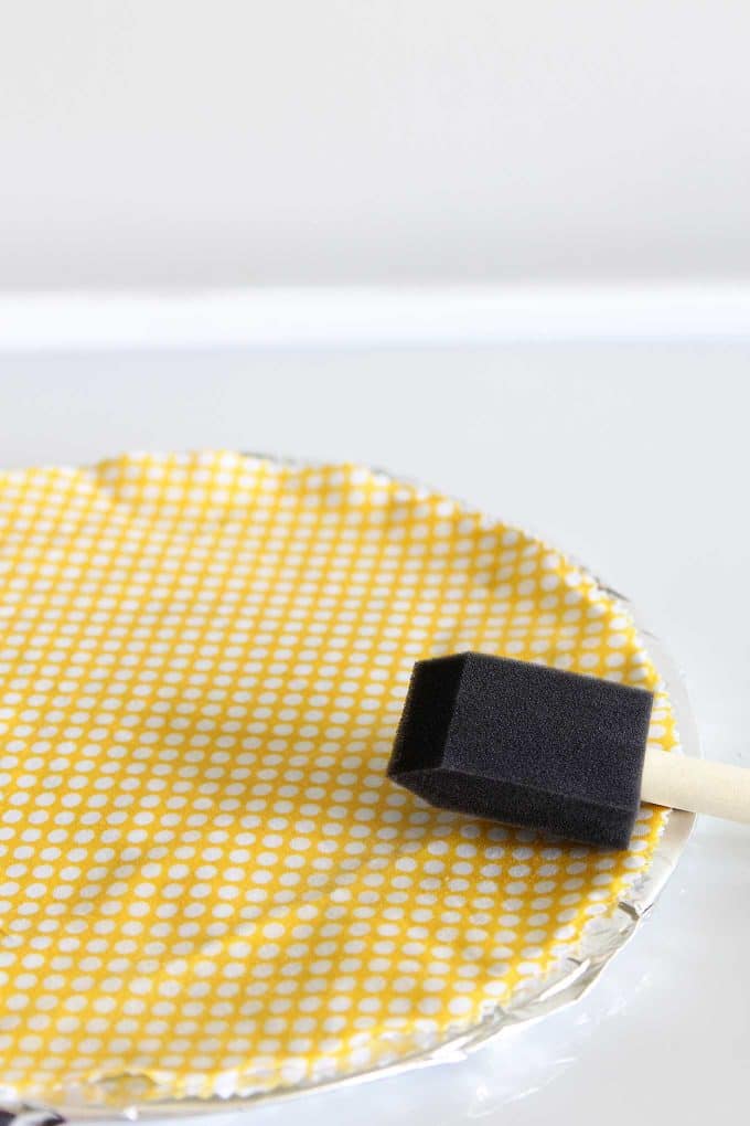 Spreading beeswax on fabric