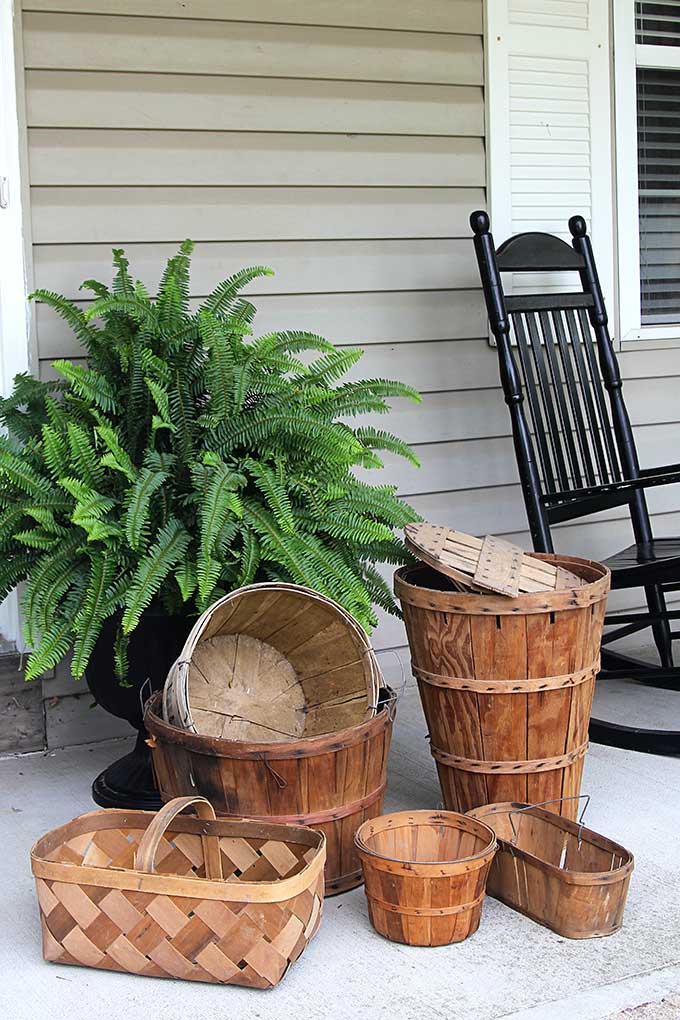 Bushel baskets are prefect to use as fall porch decor 
